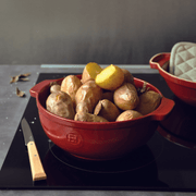 Emile Henry | Bread Pot, Charcoal, showcasing boiled potatoes, highlights its even heat distribution for perfectly roasted dishes, embodying Athens Cooks' commitment to quality kitchenware.