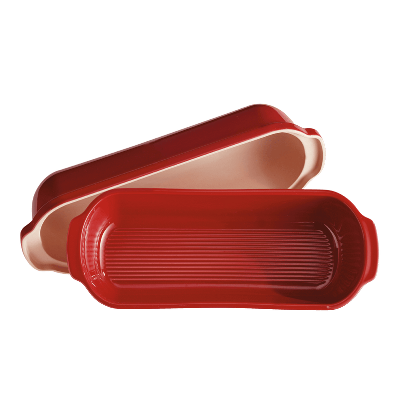 Emile Henry Loaf Bread Bakers: Long, burgundy ceramic bakeware set with a ribbed bottom and domed lid, ideal for artisan-style bread baking.