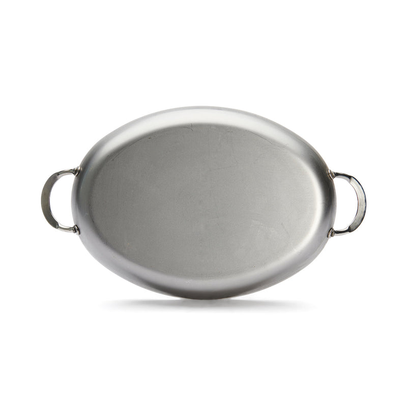 de Buyer | Oval Roasting Pan with handles, ideal for roasting meat or vegetables, enhancing any dining experience with its elegant presentation.