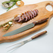 Lamson | Vintage 2pc Walnut Carving Set displayed with a slicing knife and carving fork on a wooden cutting board, highlighting precision craftsmanship.