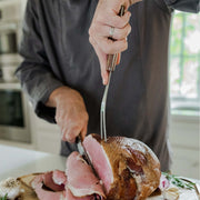 Lamson Vintage 2pc Walnut Carving Set in use, showcasing a person slicing meat with precision using the 9″ Slicing Knife from the set.