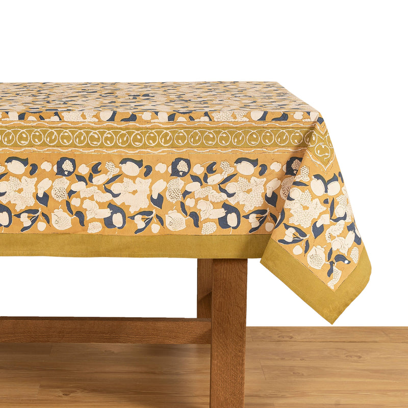 Couleur Nature - Forest Harvest Mustard & Blue Tablecloth: 59 x 86 with fruit and floral motifs on a wooden table, reflecting Provençal elegance and artisanal craftsmanship.