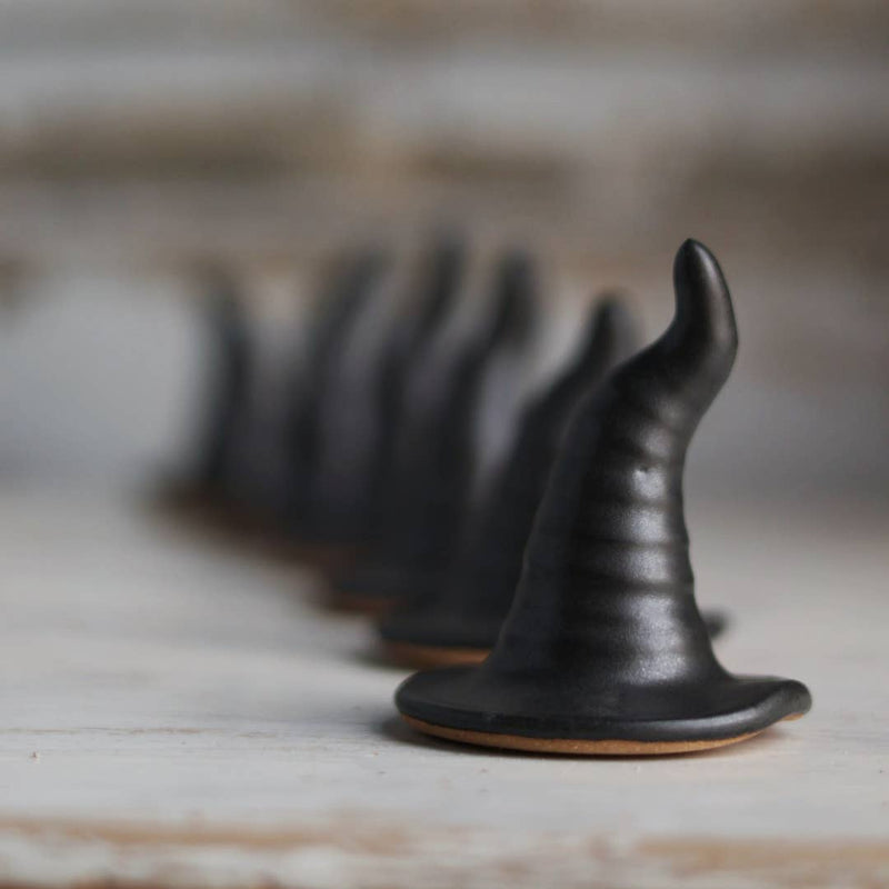 Gravesco Pottery - Black Witch Hat: Matte-black ceramic witch hat-shaped ring holder on a cookie base, perfect for Halloween decor or ring display.