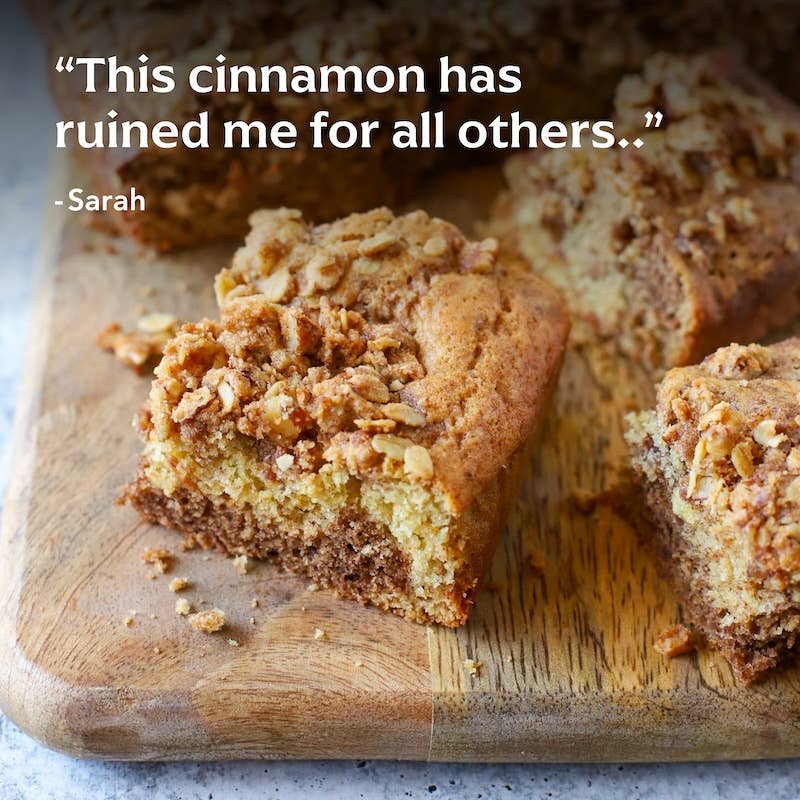 Cinnamon-swirled coffee cake squares featuring Diaspora Spices Co.'s Peni Miris Cinnamon, showcasing a crumbly oat topping and a marbled cinnamon-sugar ribbon.