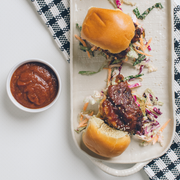 Sliders with barbecued chicken and coleslaw, complemented by Beth's Farm Kitchen BBQ Sauce, showcasing the Athens Cooks specialty food offering.