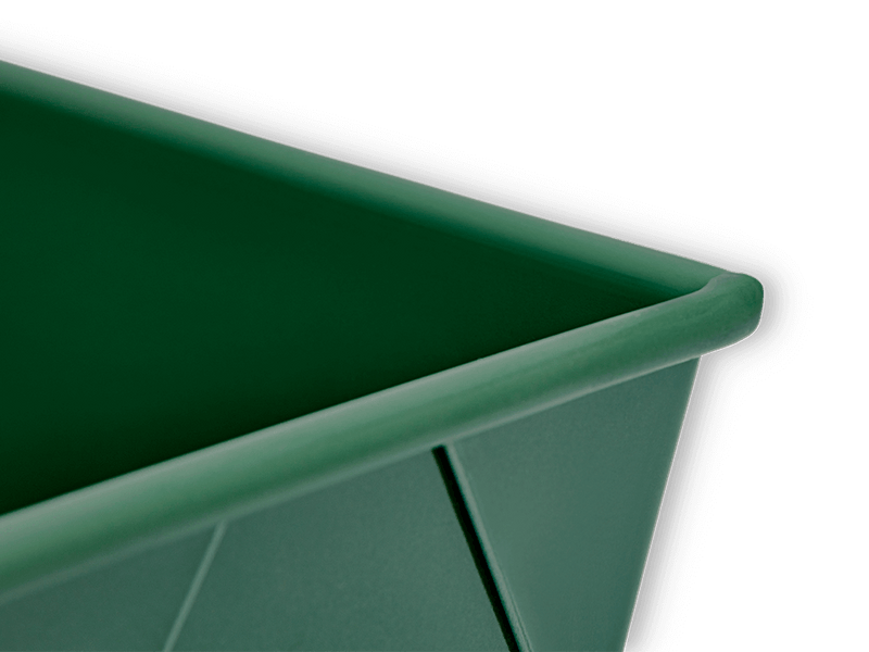 Great Jones | Breadwinner - Raspberry loaf pan with a unique wavy, corrugated bottom, designed for easy release and scratch resistance, featured against a black background.