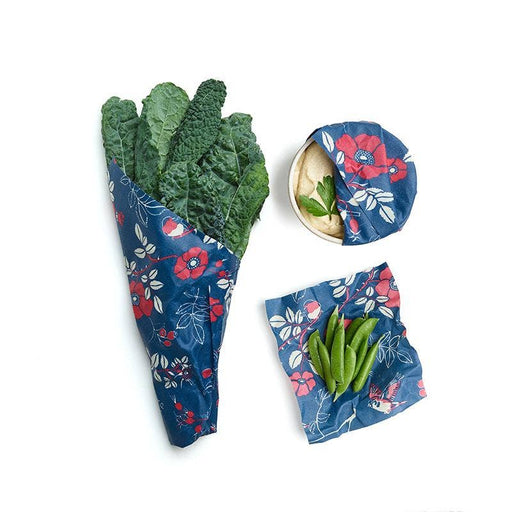 Bee's Wrap - Assorted 3 Pack - Botanical: three floral-patterned wraps, one covering kale, another a bowl, and a third under sugar snap peas.