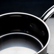 Hestan NanoBond | Cookware, 3qt Saucepan + Lid: Overhead view highlighting its polished stainless-steel interior and ergonomic handle, showcasing durable molecular titanium construction for efficient cooking.