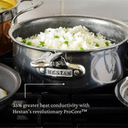 Hestan | Cookware, 1.5qt Saucepan + Lid filled with rice and peas on stove, showcasing 35% greater heat conductivity with ProCore™ technology for efficient cooking.
