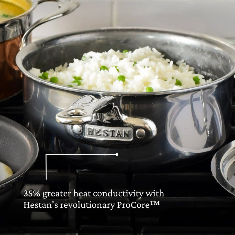Hestan | Cookware, 1.5qt Saucepan + Lid filled with rice and peas on stove, showcasing 35% greater heat conductivity with ProCore™ technology for efficient cooking.