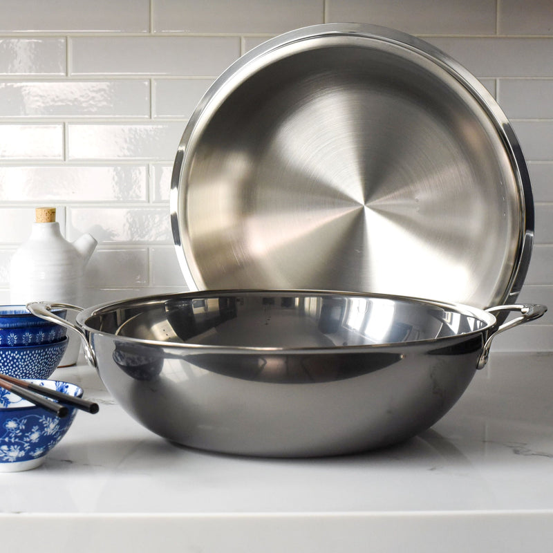 Hestan Provisions | Stainless Steel Lids Dome, 14 showcased on a kitchen counter with two handles, perfect for enhancing cooking performance and heat retention.