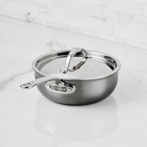 Hestan | Cookware, 2qt Saucier Pan + Lid on a marble countertop, featuring a molecular titanium finish for durability and a wide base for efficient cooking.