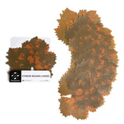 Formaticum | Cheese Board Liners - Large features a close-up of a wax-coated parchment liner with grape leaf design, highlighting its elegance for culinary displays.