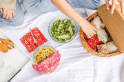 Bee's Wrap - Assorted 3 Pack - Splendid Spring reusable wraps displayed in a basket, showcasing sustainable food storage solutions for kitchen use.