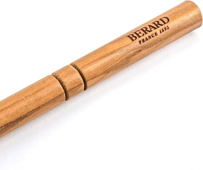 Berard Olivewood Cook's Spoon, 12 inches, handcrafted from a single olive wood piece, features a unique logo, showcasing its artisanal quality.