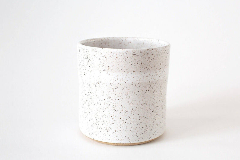 RachaelPots - Kitchen Utensil Holder: Sage, a speckled white ceramic vessel with drainage hole, perfect for organizing kitchen utensils. Hand-thrown stoneware, microwave, and dishwasher safe.