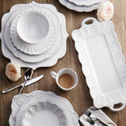 Arte Italica & Crown Linen Designs - Bella Bianca Beaded Cereal Bowl on a table set with silverware and coffee, showcasing elegant Italian craftsmanship.