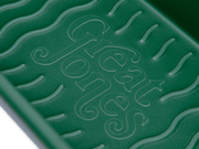 Great Jones | Breadwinner - Raspberry loaf pan with nonstick, nontoxic ceramic coating and unique wavy bottom for easy bread release, showcased in close-up detail.
