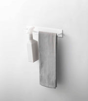 Yamazaki Home - Magnetic Kitchen Towel Hanger - Steel: White, with a spray bottle and grey towel, neatly organizes kitchen essentials in any space.
