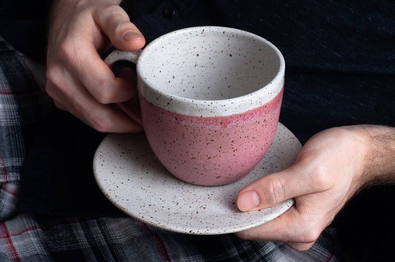 RachaelPots - 18 Oz Jumbo Mug: Nude/White, hand-thrown stoneware mug with thumb rest, held by a person, showcasing its size and craftsmanship.