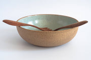 RachaelPots - Low Serving Bowl: Nude/Sage, a handmade speckled ceramic bowl with wooden utensils, showcases a glazed interior and raw exterior, perfect for stylish dining.