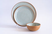 RachaelPots - Dinner Plate: Nude/White set features hand-thrown ceramic dinnerware with a speckled glaze, showcasing a dinner plate, smaller plate, and bowl on a white background.