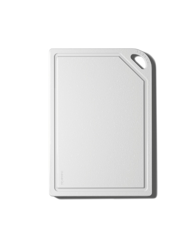 The MK Free Board: Ocean, a white, rectangular cutting board with beveled edges and a built-in handle, designed for safe, eco-friendly chopping.