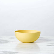 Fable New York's eco-friendly bamboo cereal bowl from the Sunsets collection, ideal for serving meals, showcased on a marble surface.