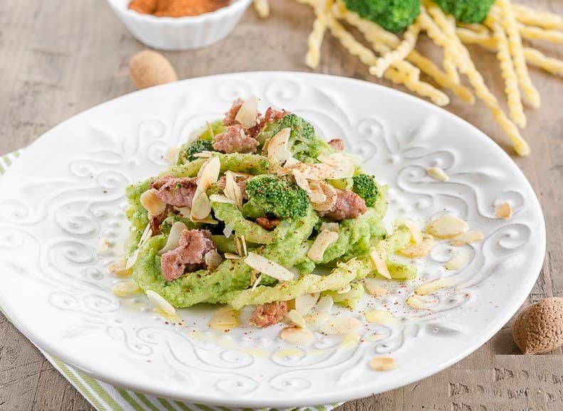 Zia Pia - Fusilli Di Gragnano pasta in broccoli sauce with sausage bits, broccoli florets, and toasted almonds, showcasing traditional Gragnano craftsmanship.