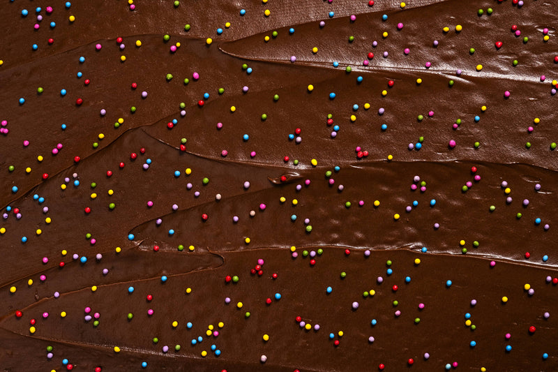 Supernatural - Dye-Free Rainbow Nonpareils Sprinkles, 3oz: A swirl of chocolate ganache topped with multicolored sprinkles, perfect for decorating homemade treats.