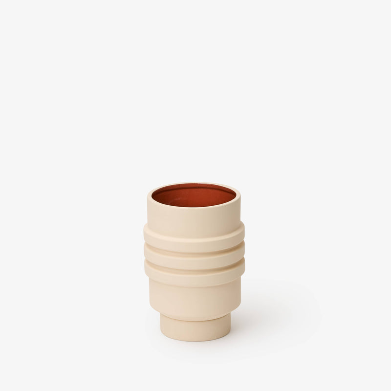 Areaware - Strata Plant Vessel: Blue, a ceramic planter with layered, stacked shapes, resembling a cylindrical object with a concealed saucer, inspired by sculptural jewelry design.