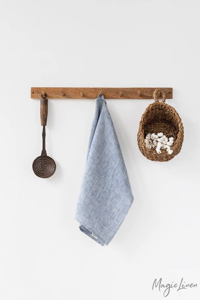 Linen tea towel on hook with basket; durable, absorbent, and made from European flax for kitchen use. Ideal for Athens Cooks' curated kitchen essentials.