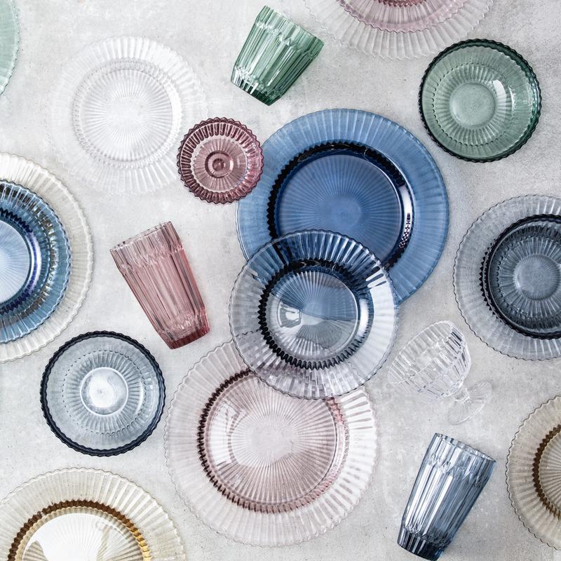 Fortessa | Archie Dusk 10oz Footed Dessert Bowl showcased among various glass dishes, highlighting its elegant design suitable for sophisticated dining experiences.