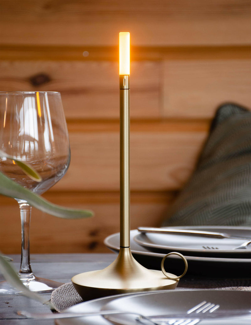 VANMOKUM | GRAYPANTS Wick Portable Rechargeable Lamp - Black, displayed on a table setting with tableware, embodies ambient lighting and connectivity through its elegant, cordless design.