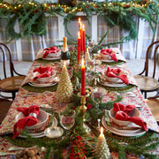 Couleur Nature - Noel Red & Green French Tablecloth, 71 x 71, adorns a festive table with evergreen accents, red berries, and elegant place settings for a warm holiday gathering.