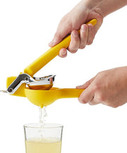 Chef'n | Citrus Juicers - Lemon Juicer Fresh Force Plus being used to squeeze juice into a glass, showcasing its efficient dual-gear mechanism.