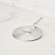 Hestan Provisions | Commercial Clad Stainless Steel Universal Lids, 8.5 Inches, featuring a laser-etched signature, vent holes, and durable handle on a marble countertop.