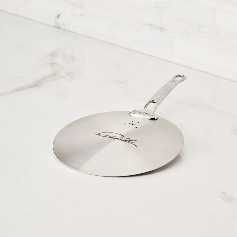 Hestan Provisions | Commercial Clad Stainless Steel Universal Lids, 8.5 Inches, featuring a laser-etched signature, vent holes, and durable handle on a marble countertop.