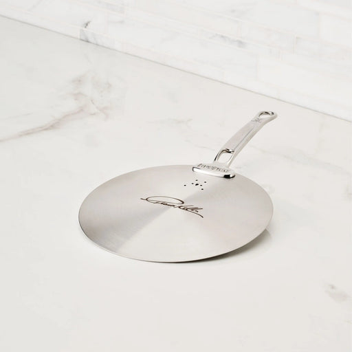 Hestan Provisions | Commercial Clad Stainless Steel Universal Lids, 8.5 Inches, featuring a laser-etched signature, vent holes, and durable handle on a marble countertop.