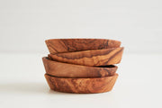 Set of four hand-carved Italian olivewood Aperitivo bowls, showcasing warm natural grain, perfect for appetizers, crafted by artisans in Umbria, Italy.