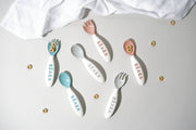 BEABA Toddler's Self-Feeding Cutlery - Breeze, featuring a close-up of a spoon and fork set, designed for safe, ergonomic self-feeding, displayed on a white surface.