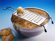 Rösle Coarse Grater with Wire Handle and Food Grip Hand Guard, ideal for grating firm vegetables, cheese, and chocolate, shown with stainless steel and silicone design. Dishwasher safe.