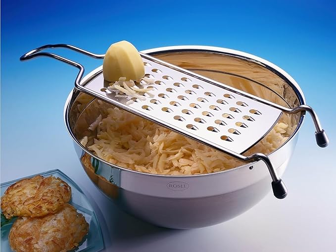 Rösle Coarse Grater with Wire Handle and Food Grip Hand Guard, ideal for grating firm vegetables, cheese, and chocolate, shown with stainless steel and silicone design. Dishwasher safe.