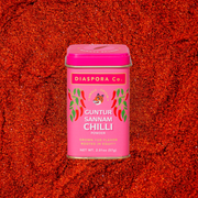 Diaspora Co. Spices - Guntur Sannam Chilli: Pink container with a lid featuring a tiger illustration and spice label, containing ground Sannam chillies.