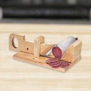 Zassenhaus Charcuterie Slicer on a wooden block, featuring a slice of sausage and knife, highlighting its precision and craftsmanship for culinary enthusiasts.