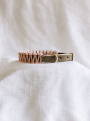 EMBER & IVORY - Olive/Blush Macrame & Leather Dog Collar: S (10 1/2 - 13 3/4), features a peach macramé cord with brass hardware on taupe leather, resting on soft fabric.