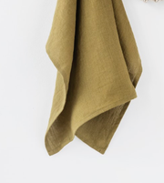 Ruffle trim tea towel in linen, close-up view, highlighting its soft texture and durability, ideal for kitchen use at Athens Cooks.