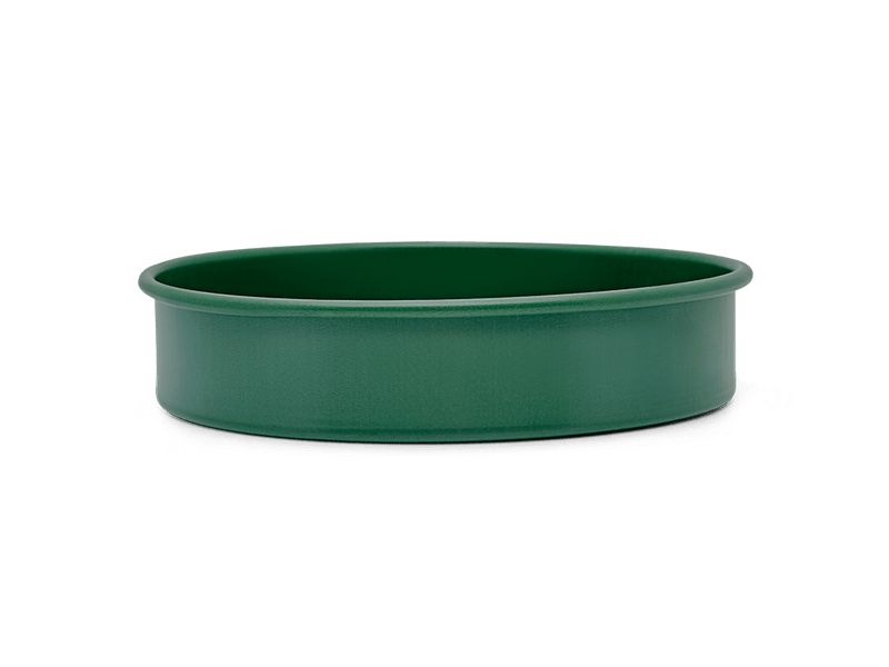 Great Jones | Patty Cake - Broccoli, featuring a wavy, corrugated bottom for easy release, crafted from nonstick ceramic for even baking. Oven and dishwasher safe.