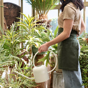 The Floral Society | Watering Can - White: A modern, copper-plated stainless steel watering can with a curved handle and extended spout, perfect for gardening tasks.