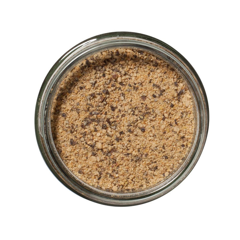 San Juan Island Sea Salt - Burger and Steak Seasoning Blend in a glass jar, showcasing a light brown coarse powder with darker flecks.